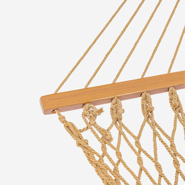 Close-up of a rope hammock with wooden bar on a white background