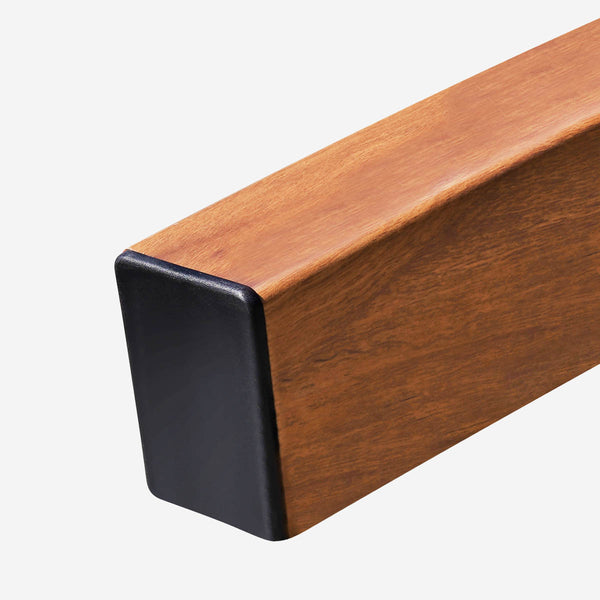 Wooden bar with black rectangular end cap on a white background