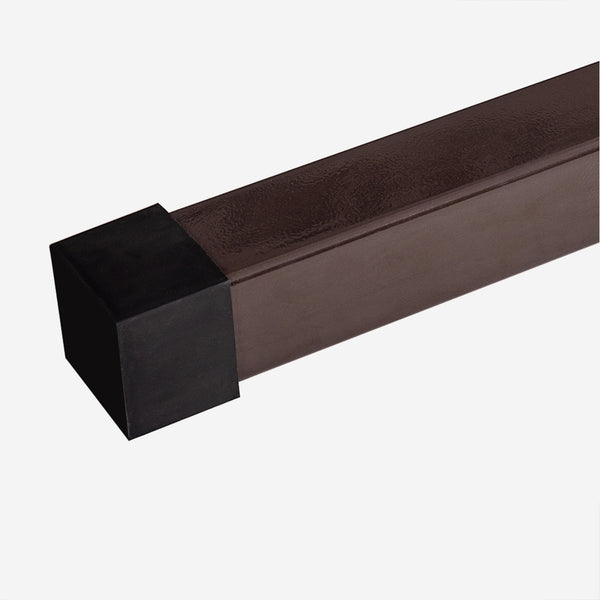 Brown metal rod with black square end on a white background