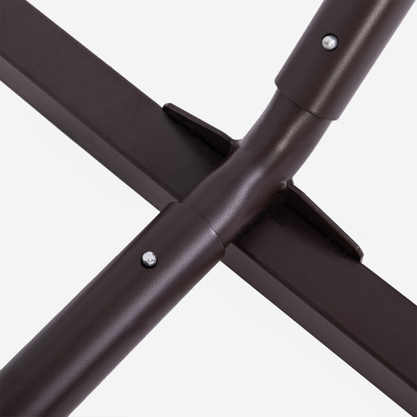 Close-up of a brown metal frame with screws on a white background