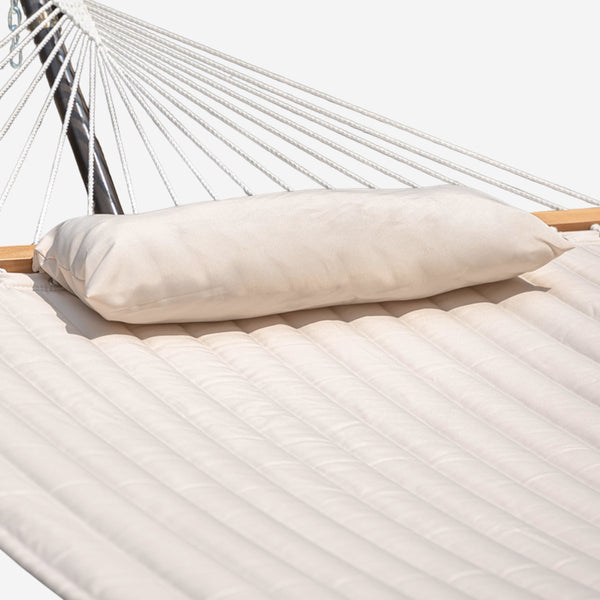 Beige body pillow on a white hammock
