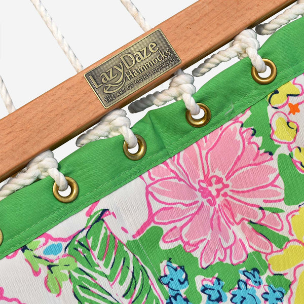 Close-up of a floral-patterned hammock with a wooden rod and 'LaZ Daze Hammocks' label.