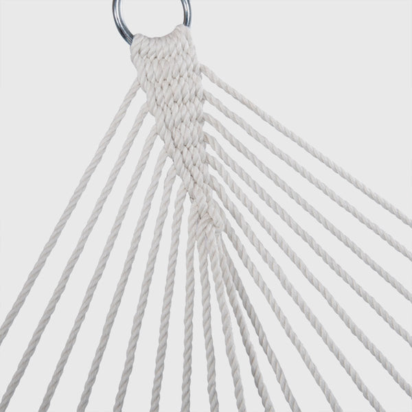 Close-up of a white rope hammock with a metal ring on a light gray background