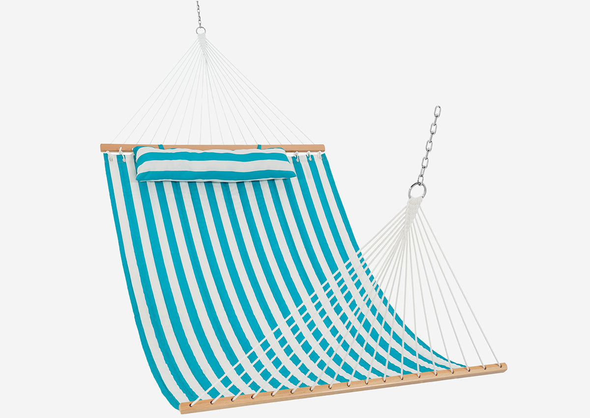 Teal and white striped hammock hanging against a white background