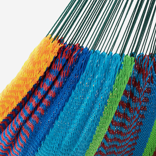 Close-up of a colorful woven fabric with blue, green, orange, and red patterns.