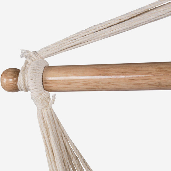 Close-up of a wooden hammock rod with a white rope on a white background