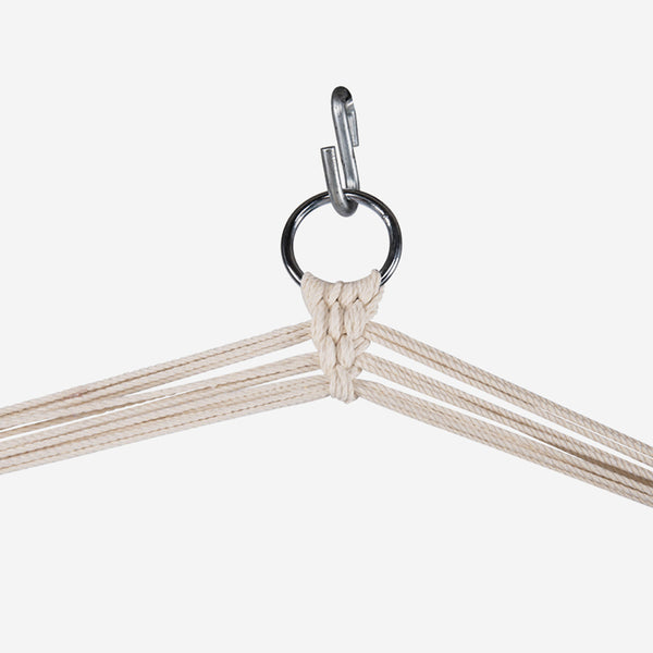 Close-up of a beige hammock with metal rings on a white background
