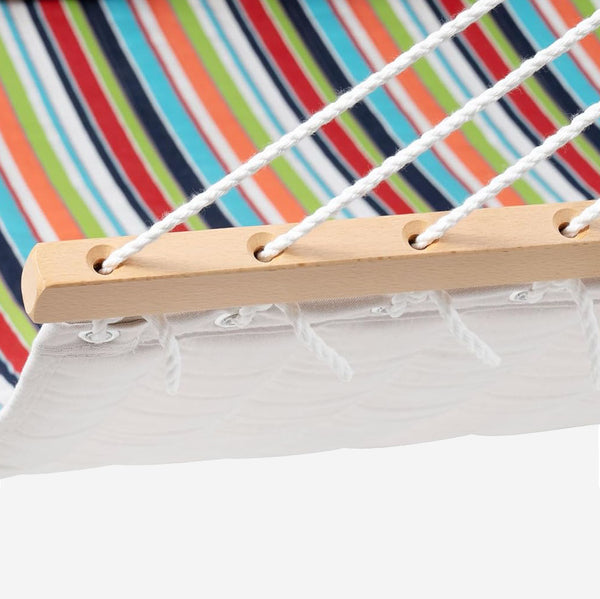 Close-up of a hammock with colorful striped background