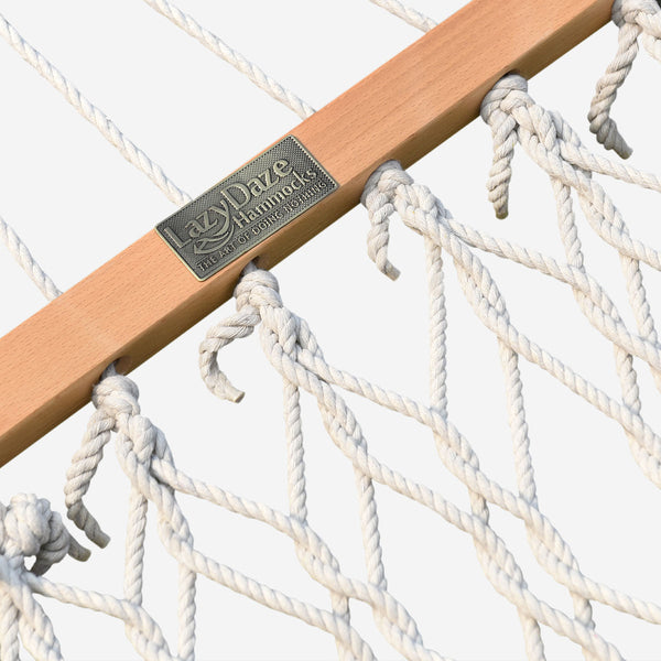 Close-up of a hammock with a wooden rod and visible brand name 'Daze Hammocks'.