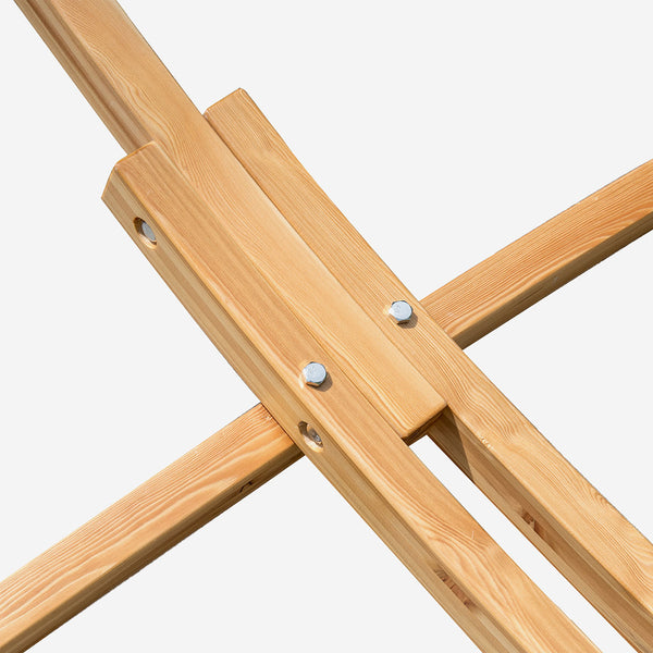 Close-up of a wooden easel with metal brackets on a white background