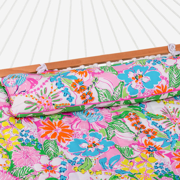 Colorful floral-patterned hammock with wooden frame on a white background