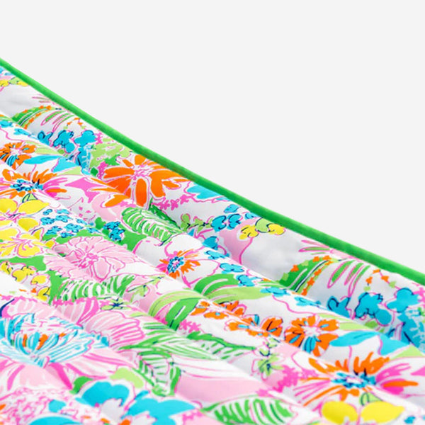 Colorful floral fabric with a green border on a white background