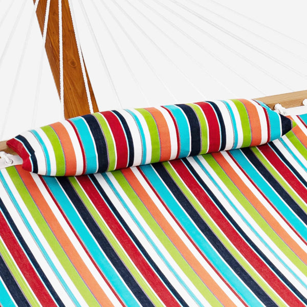 Colorful striped hammock with wooden frame and white ropes