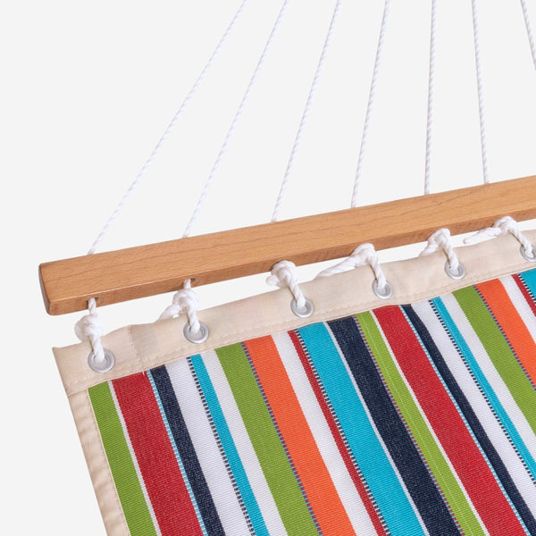 Colorful striped hammock with wooden frame and metal hooks on a white background