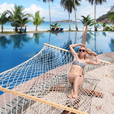 Woman relaxing on Lazy Daze Double Traditional Cotton Rope Hammock with Pillow by the poolside.#color_with-pillow