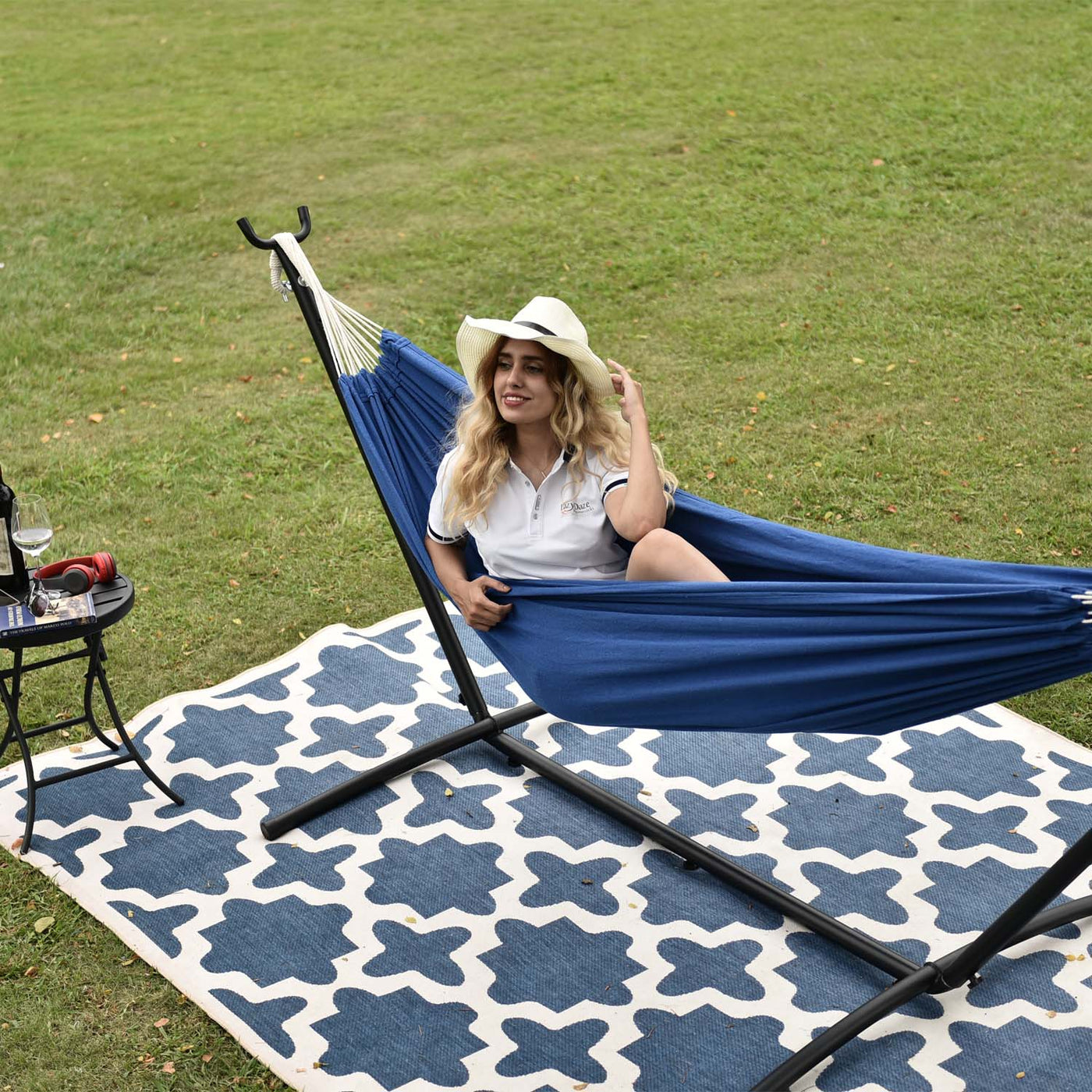 A woman enjoying the Lazy Daze brazilian hammock combo outdoors.#color_dark-blue