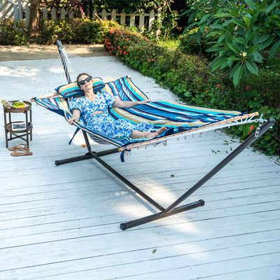 Woman relaxing in a Lazy Daze Cotton Rope Hammock Combo in the backyard.#color_beach