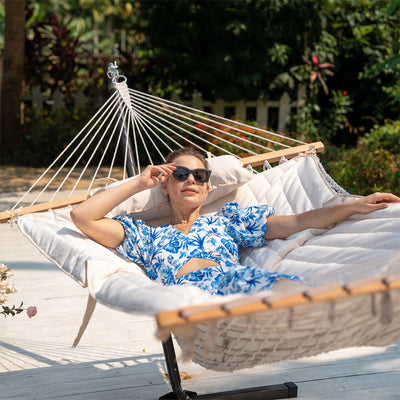 Enjoying a peaceful afternoon in a Lazy Daze Cotton Rope Hammock Combo.#color_beige