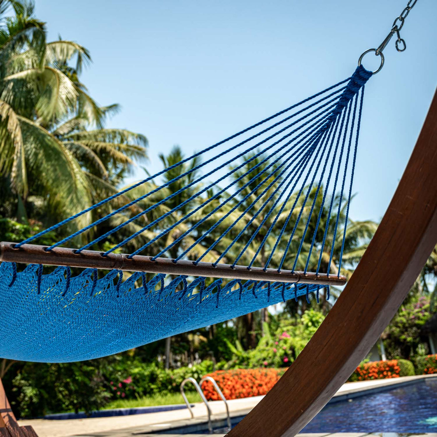 Detailed view of the hardwood spreader bar on the Lazy Daze Double Caribbean Rope Hammock in Blue.#color_blue