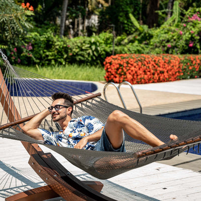 Enjoying the sun on Lazy Daze Double Caribbean Rope Hammock in Gray in the backyard.#color_gray