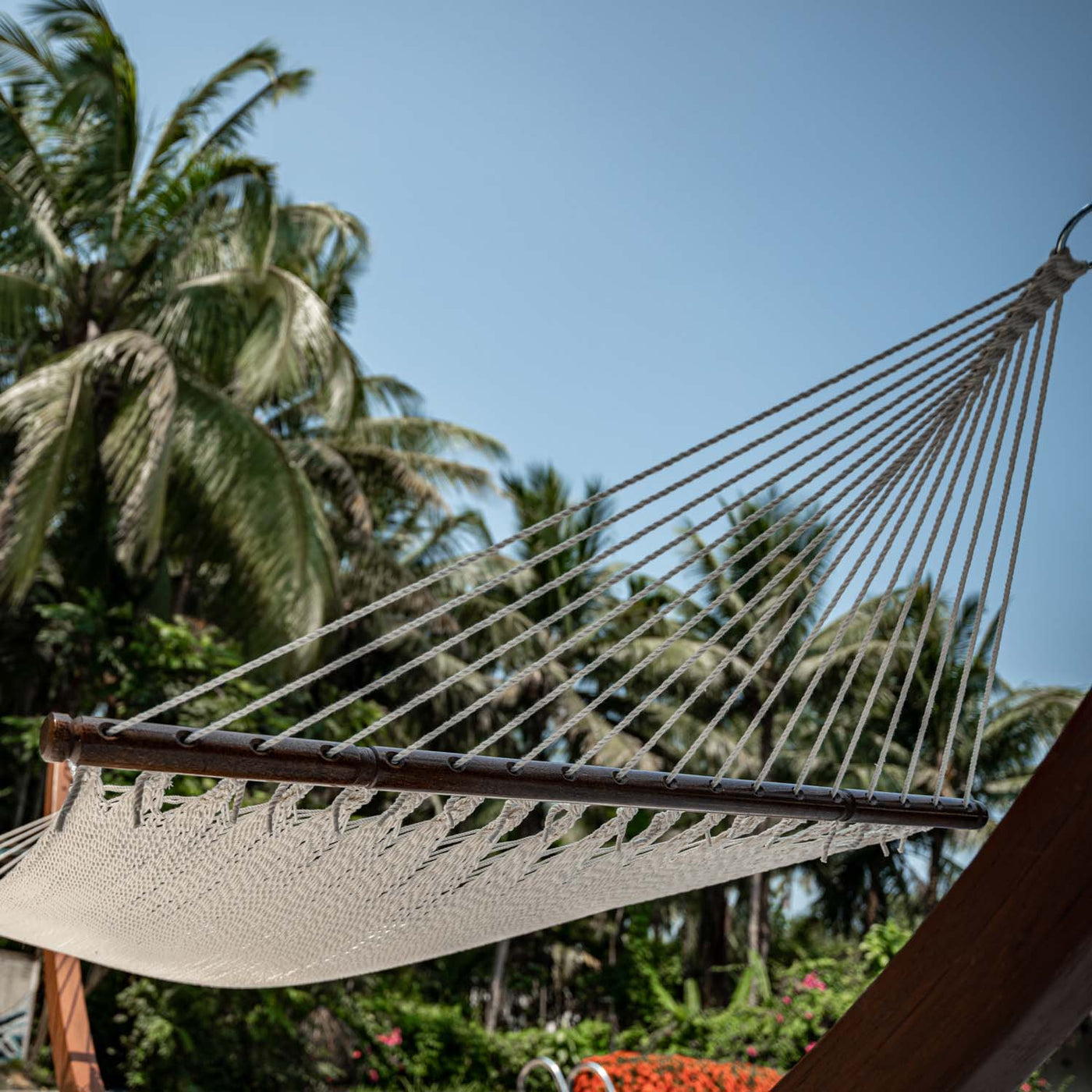 Detailed view of the hardwood spreader bar on the Lazy Daze Double Caribbean Rope Hammock in Gream. #color_gream