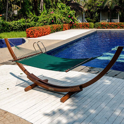 Lazy Daze Double Caribbean Rope Hammock in Green placed by the poolside in a backyard.#color_green