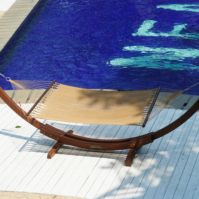 Poolside view of the Lazy Daze Double Caribbean Rope Hammock in Tan, showcasing its elegant design.#color_tan