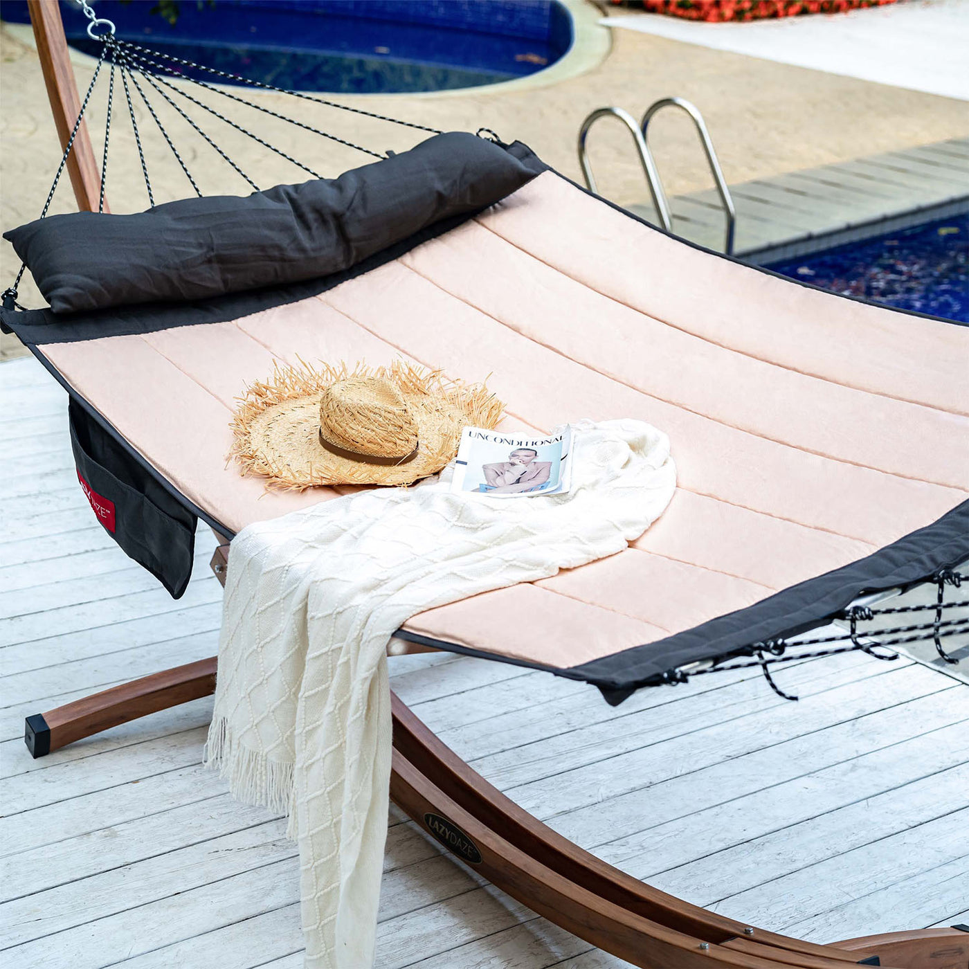 Lazy Daze Double Hammock with Curved Spreader Bar in khaki placed near a pool in the backyard.#color_khaki