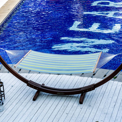 Lazy Daze Double Poolside Hammock in Blue Stripes set up by the poolside.#color_blue-stripes