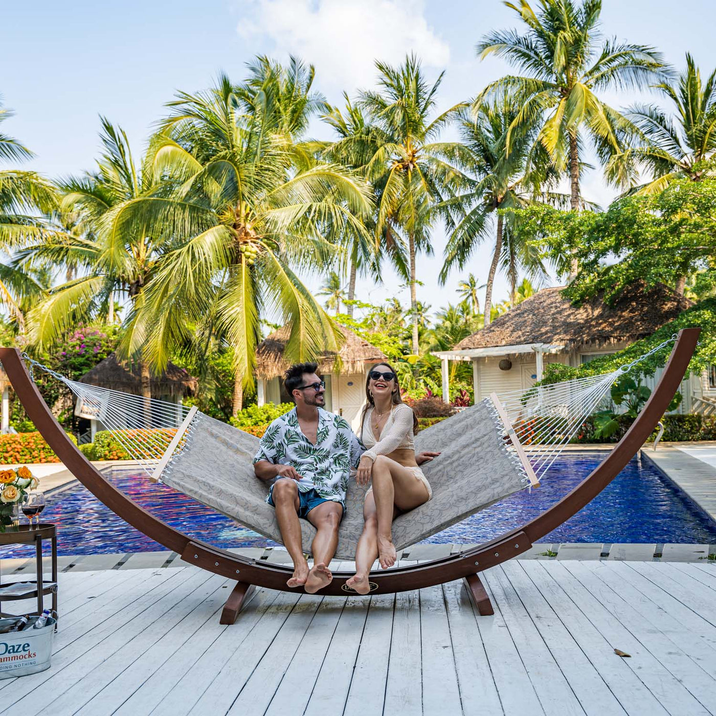 Relaxing on the Lazy Daze Double Poolside Hammock in Vines by the poolside, perfect for unwinding under the sun.#color_vines