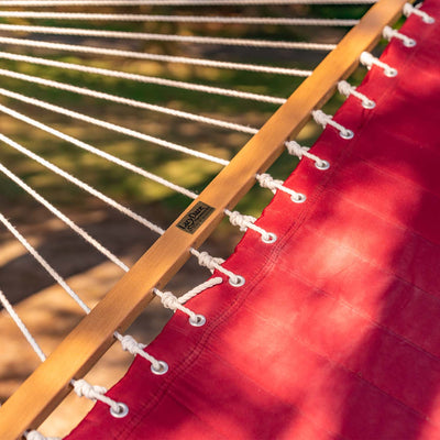 Hardwood spreader bar detail on the Lazy Daze double quilted hammock in burgundy, ensuring stability.#color_burgundy