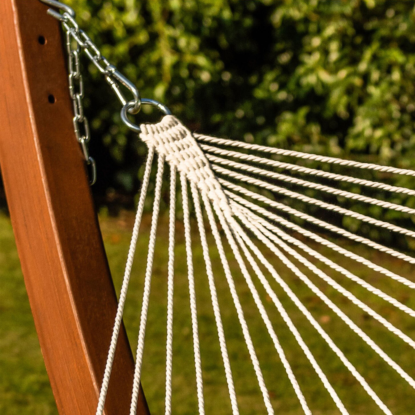 Close-up of the crafted rope knot on the Lazy Daze double quilted hammock in dark green.#color_dark-green