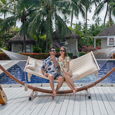 Lazy Daze Quilted Hammock with tassels showcasing a peaceful outdoor scene in the backyard.#color_natural-solid-with-tassels