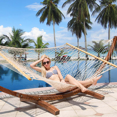 Woman enjoying a peaceful moment on the Lazy Daze Double Traditional Cotton Rope Hammock with Pillow.#color_with-pillow