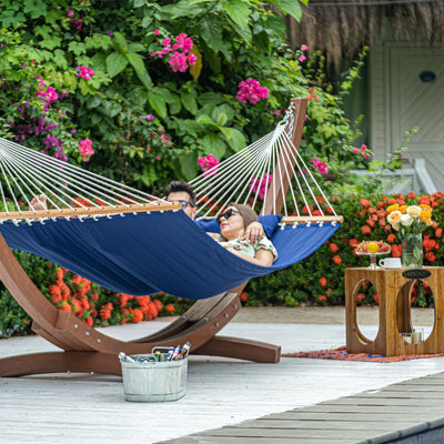 Couple enjoying a Lazy Daze Large Double Quilted Hammock in Dark Blue in the backyard.#color_dark-blue