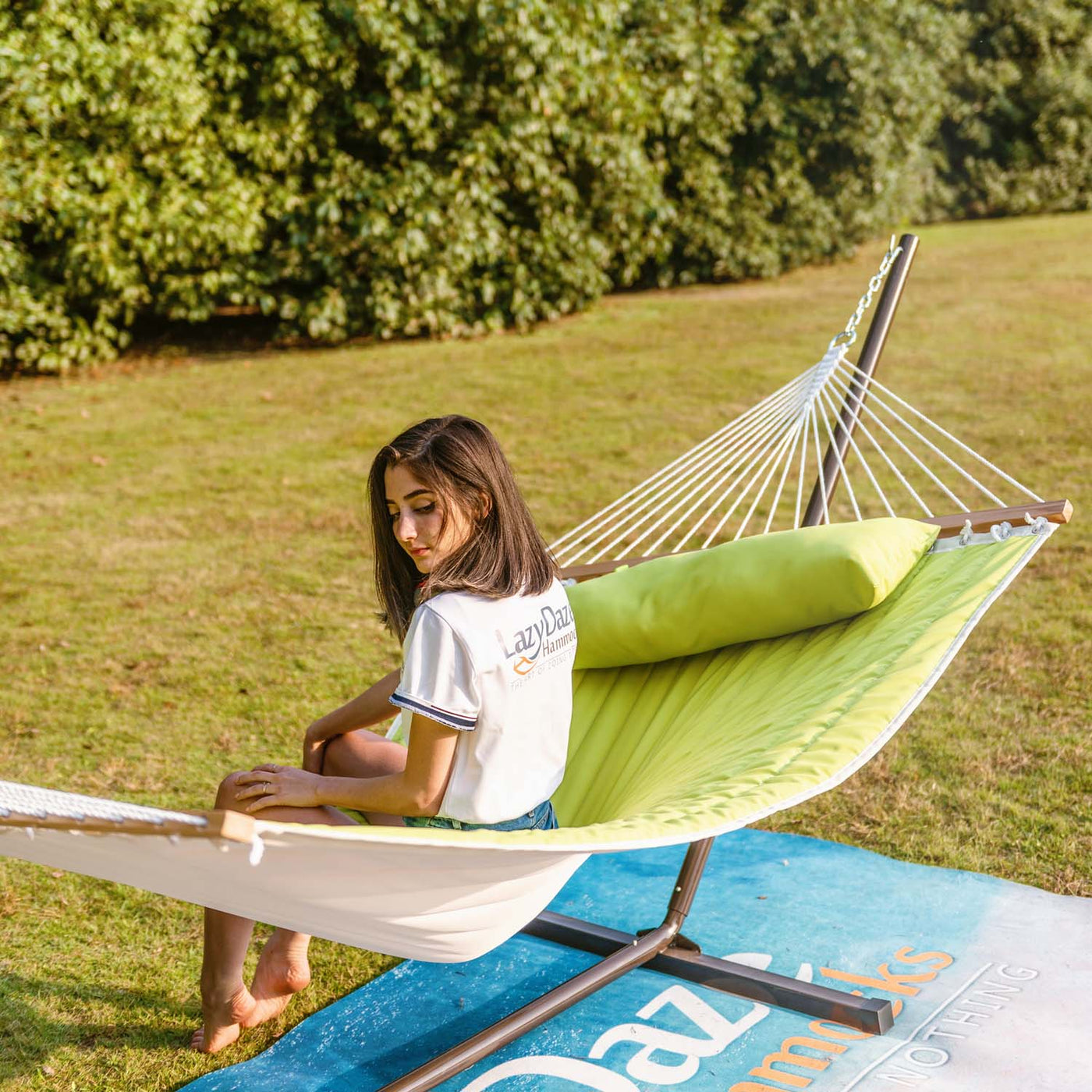 Lazy Daze large double quilted hammock in lemon green resting comfortably on a grassy lawn outdoors.#color_lemon-green