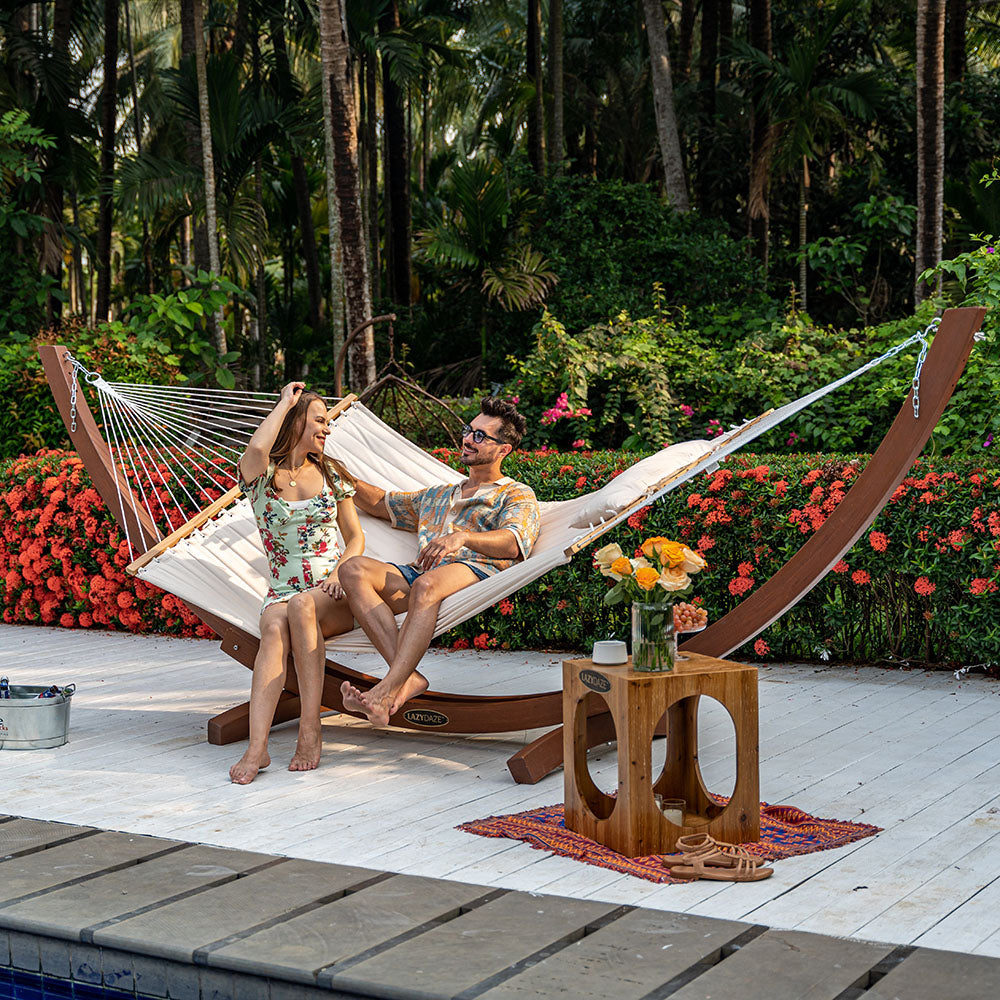 Couple relaxing on Lazy Daze Large Double Quilted Hammock in Natural Solid, backyard.#color_natural-solid