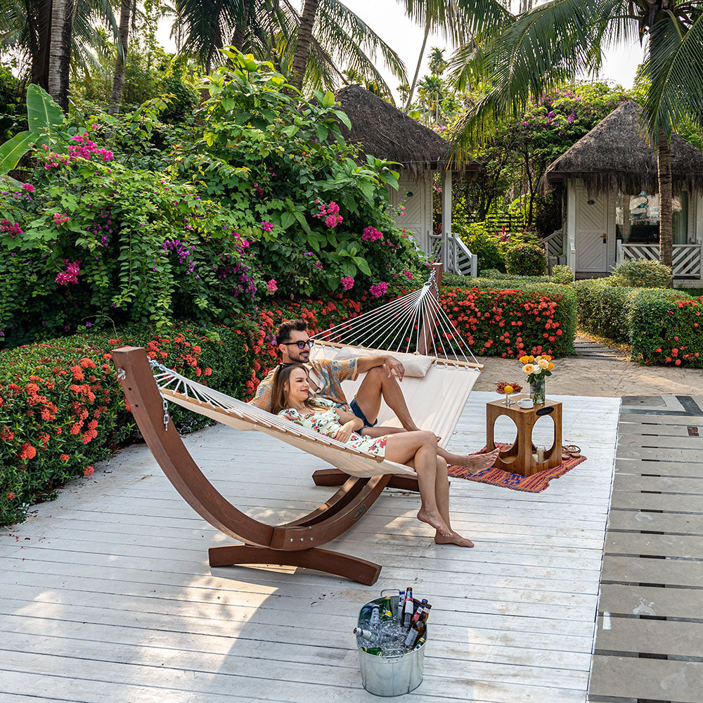 Couple lounging together on Lazy Daze Large Double Quilted Hammock, backyard.#color_natural-solid