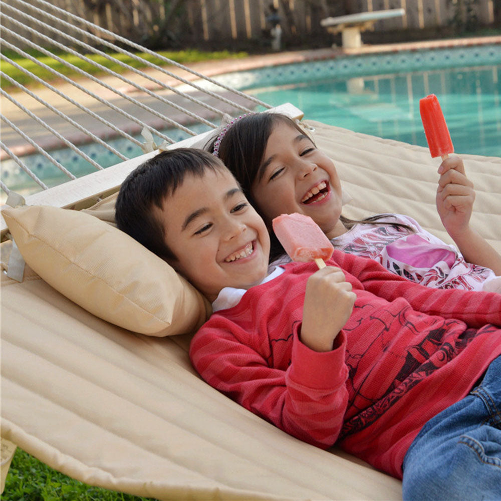 Children lie on Lazy Daze large double quilted hammock with stand.