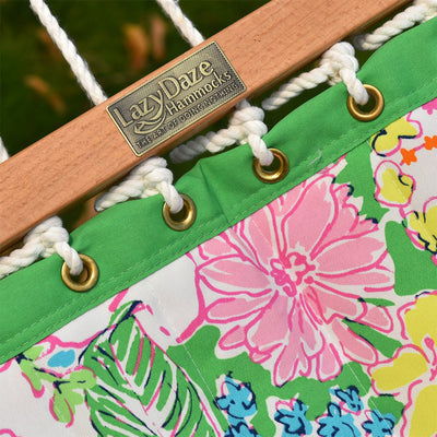 Close-up of Lazy Daze double reversible quilted hammock, showcasing the hardwood spreader bar and floral print.#color_floral