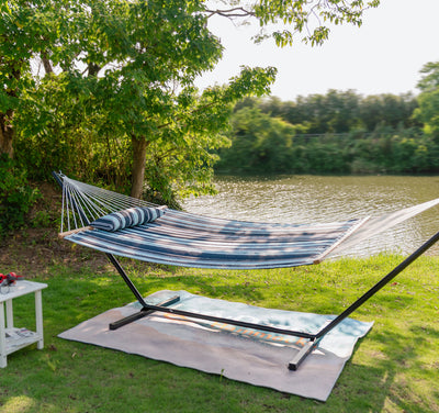 Aqua Navy Lazy Daze Large Double Stripes Quilted Hammock set up on a tranquil outdoor lawn.#color_aqua-navy