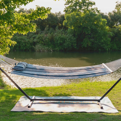 Lazy Daze Large Double Stripes Quilted Hammock in Aqua Navy displayed in a sunny backyard setting. #color_aqua-navy