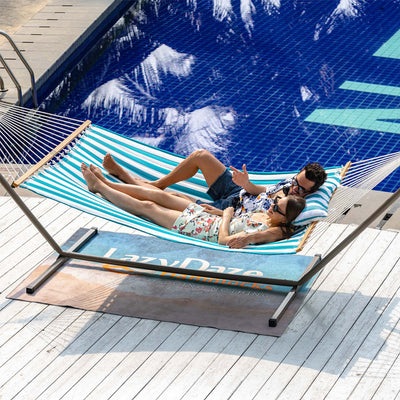 Lazy Daze Large Double Stripes Quilted Hammock in Aqua White Stripes, backyard with a couple relaxing.#color_aqua-white-stripes