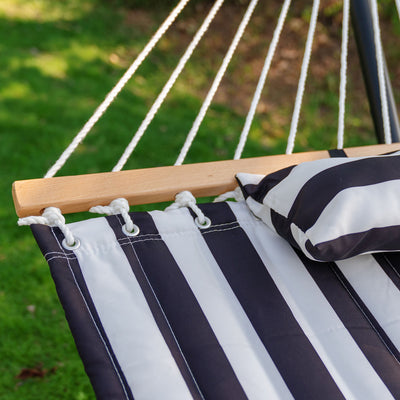 Durable hardwood spreader bar of the Lazy Daze stripes quilted hammock, designed for stability.#color_black-white-stripes