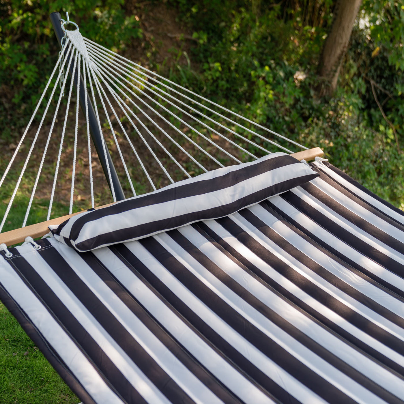 Cozy fabric and pillow of the Lazy Daze Black White Stripes Quilted hammock, ensuring comfort.#color_black-white-stripes