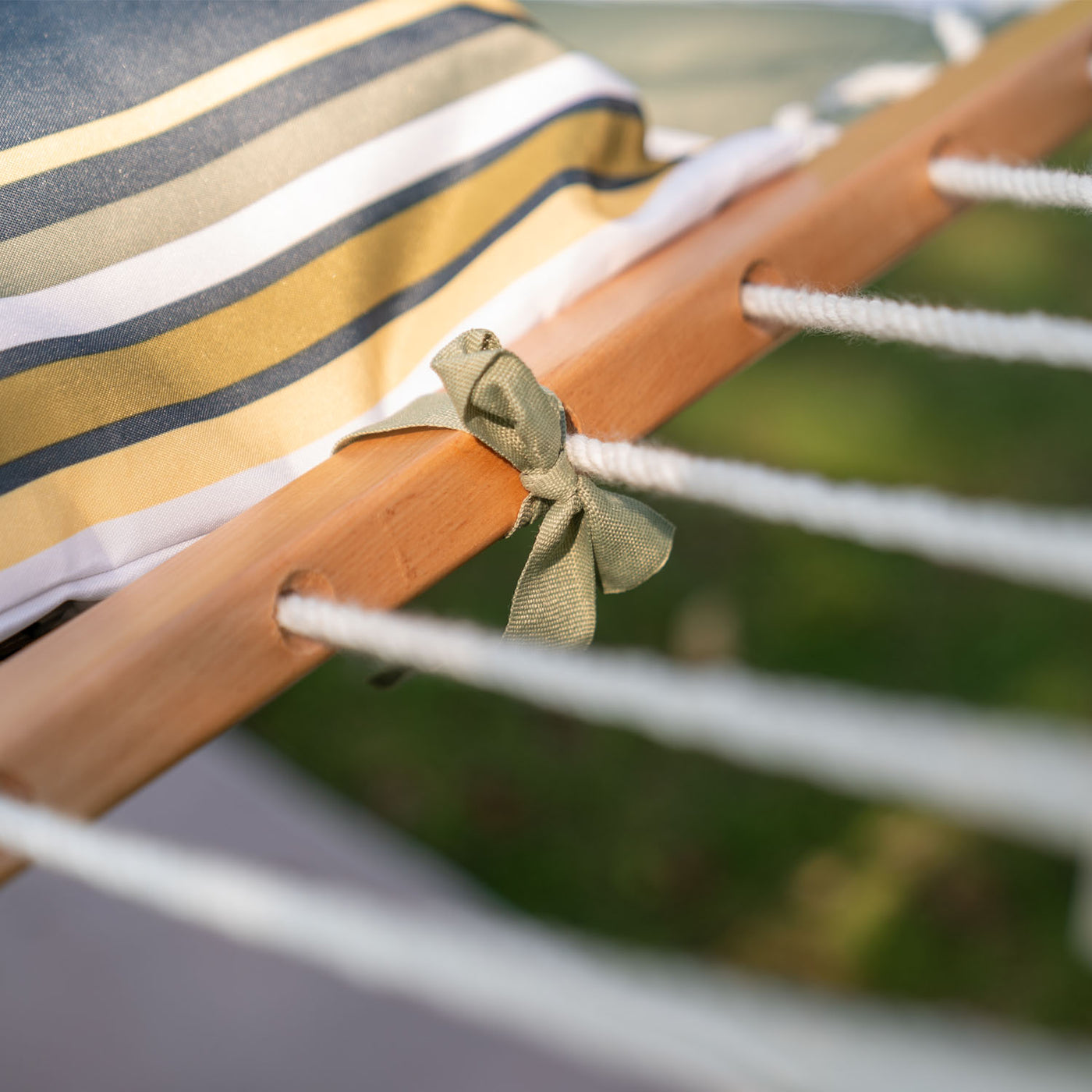 Sturdy hardwood spreader bar of the Lazy Daze Large Double Stripes Quilted Hammock in Forest Stripes.#color_forest-stripes