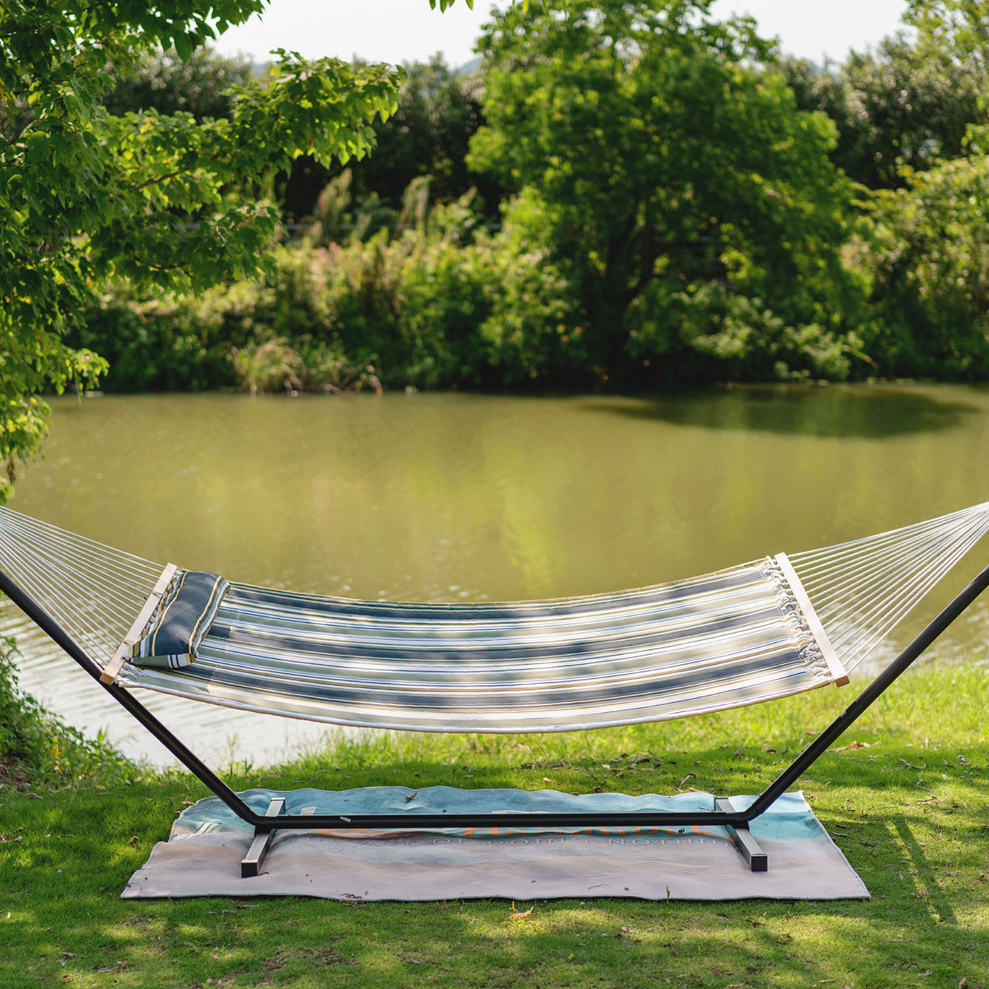 Forest Stripes Lazy Daze Large Double Stripes Quilted Hammock displayed outdoors in a grassy area.#color_forest-stripes