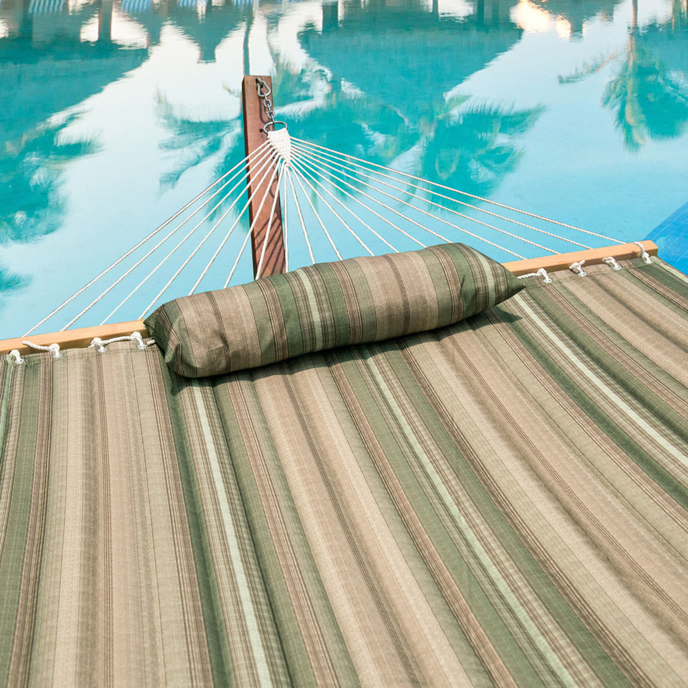 Comfortable fabric and detachable pillow of the Lazy Daze Large Double Stripes Quilted Hammock.#color_green-brown-stripes