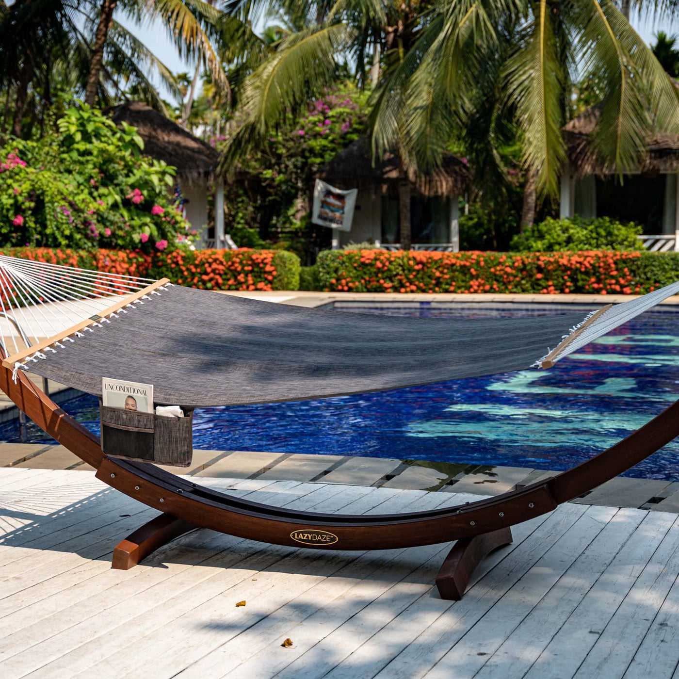 Lazy Daze Quick Dry Hammock in Black by the poolside, perfect for outdoor lounging.#color_black