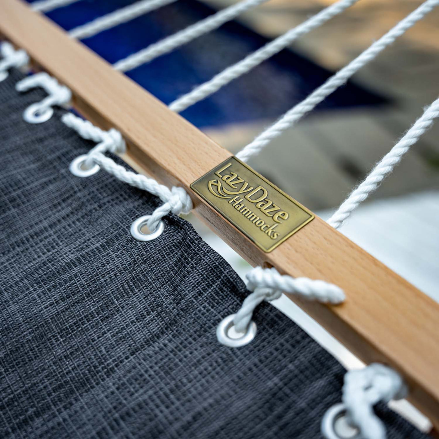 Close-up of the hardwood spreader bar on the Lazy Daze Quick Dry Hammock Olefin Blend Textliene in Black. #color_black